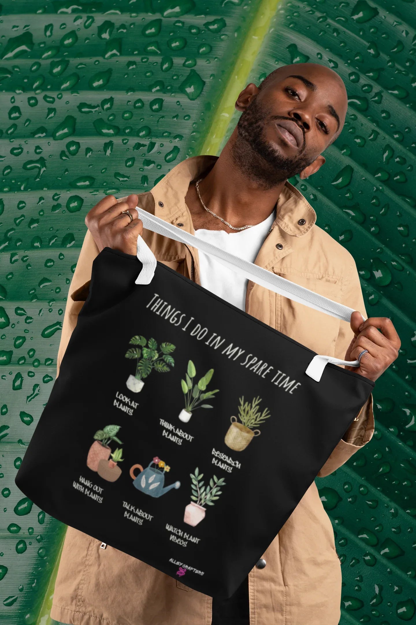 Black tote bag with white handles, plant graphic and 'THINGS I DO IN MY SPARE TIME'.