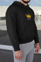 Black hooded sweatshirt with KING crown graphic on chest, worn with sleeves down