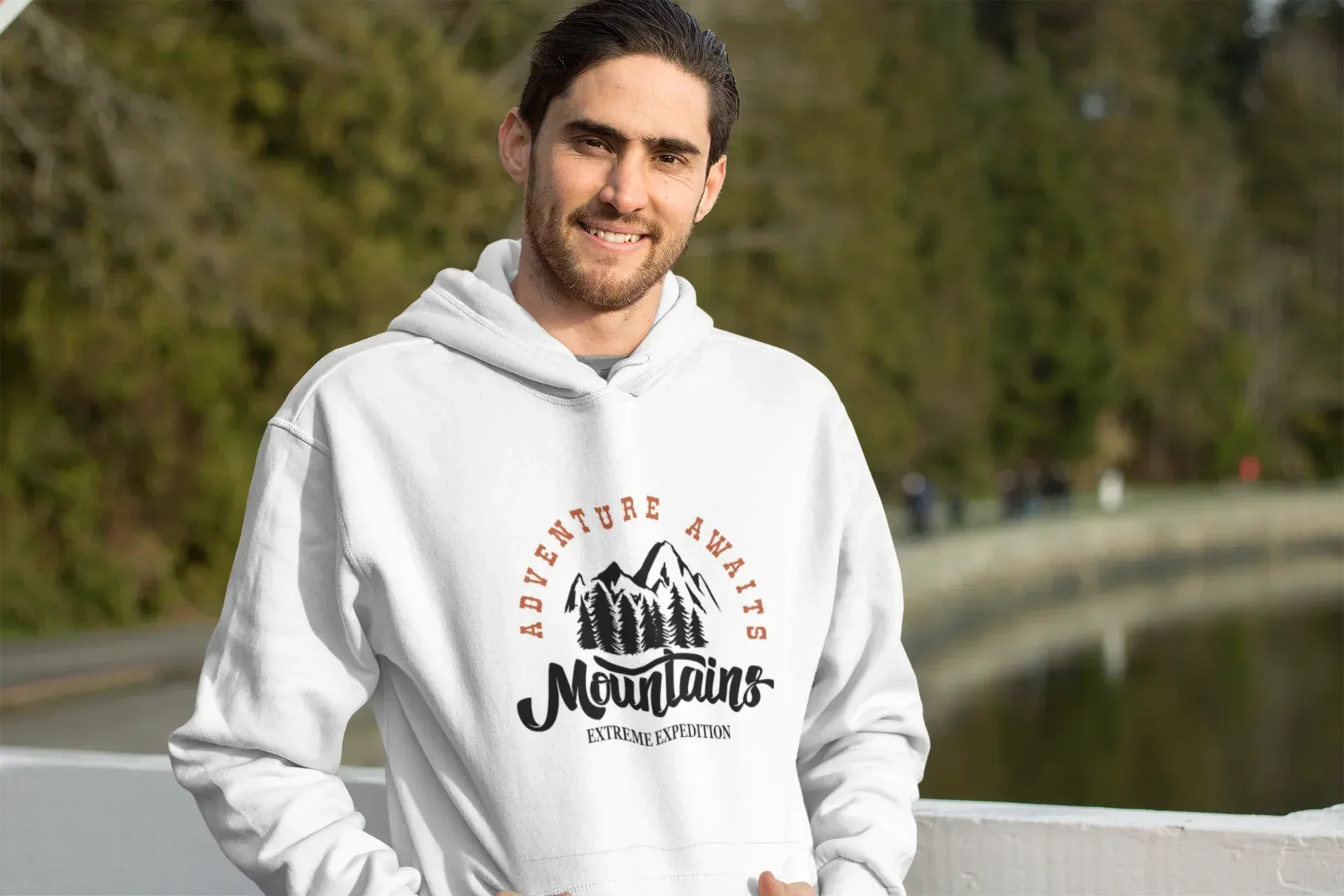 White hoodie with hood and Adventure Awaits mountain logo on front