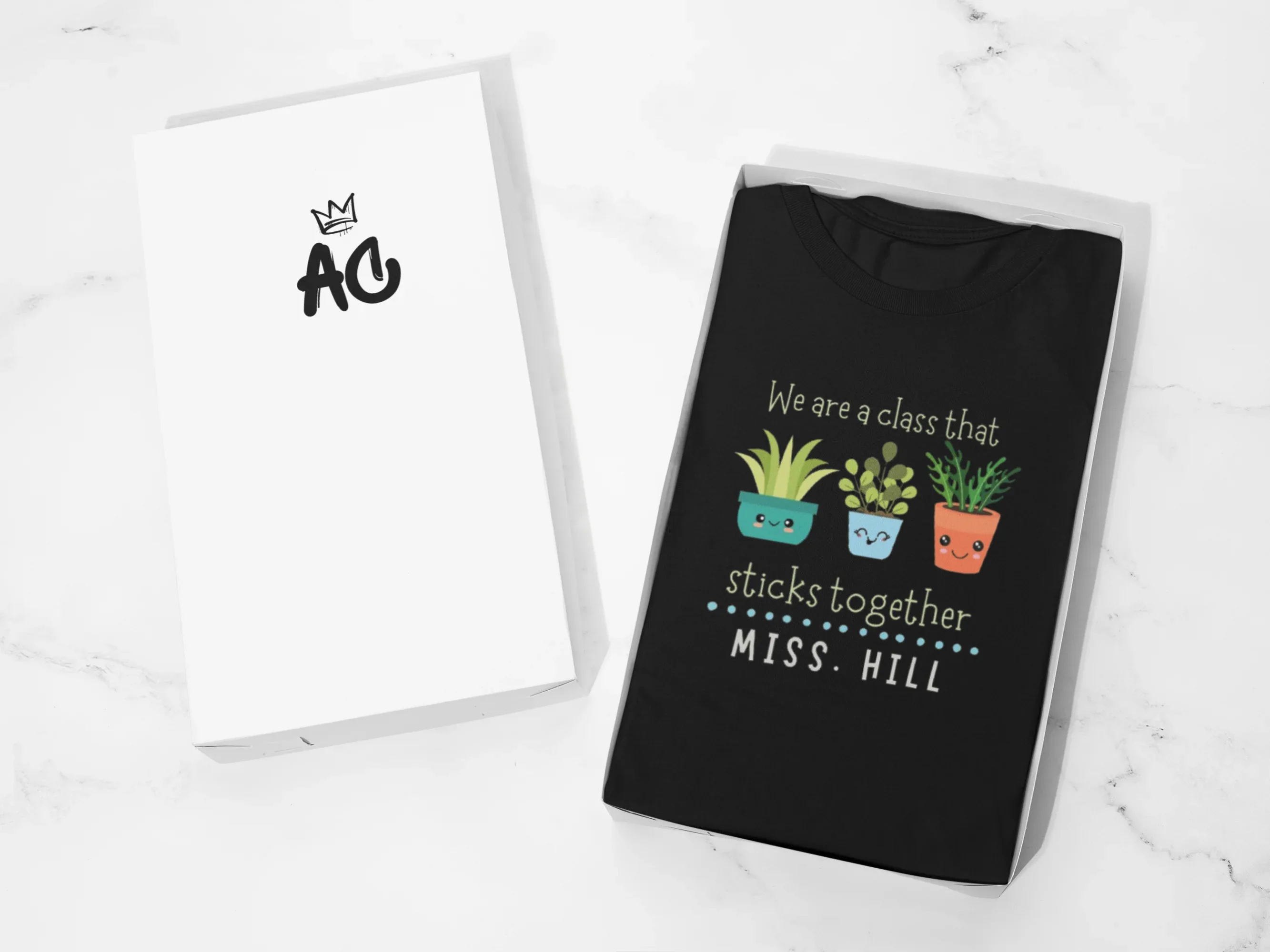 Black crewneck T-shirt with cartoon plants and 'We are a class that sticks together'.