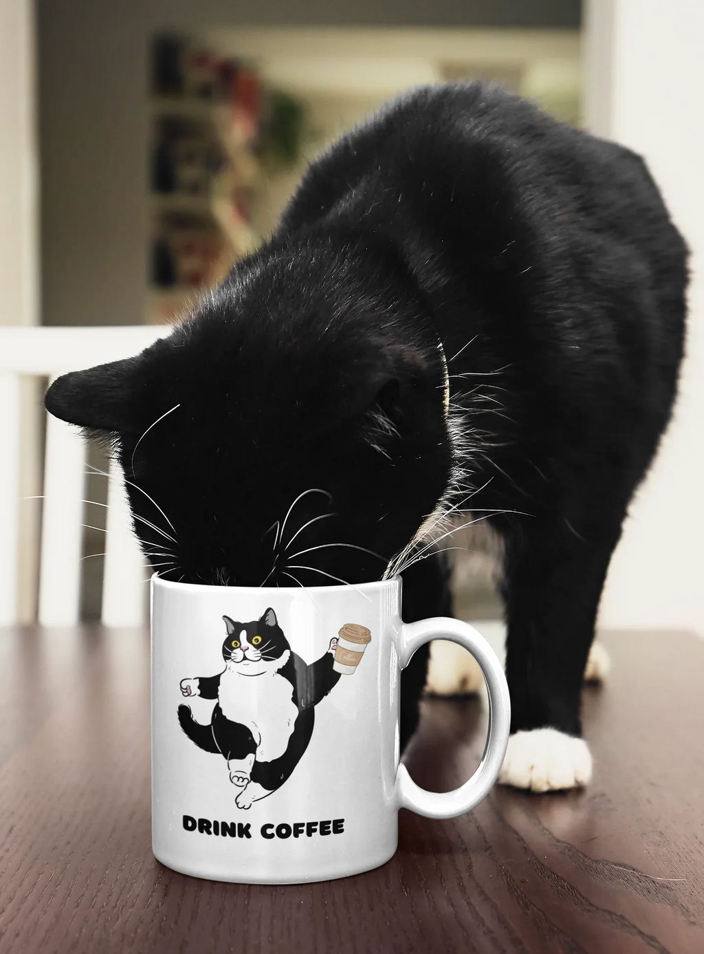 White coffee mug with cat graphic holding a drink and 'DRINK COFFEE' text.