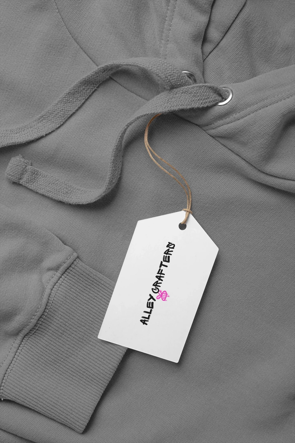 Dark gray kids hoodie with drawstring hood, kangaroo pocket, and attached product tag