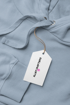 Light blue hoodie close-up with drawstring hood, cuff ribbing, and brand hang tag