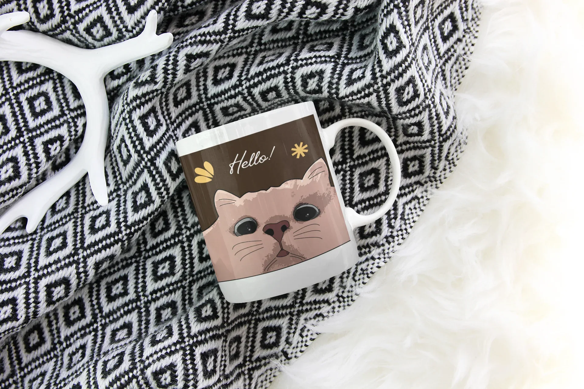 White ceramic mug with cat face and 'Hello!' text graphic on front