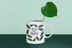 White 11oz coffee mug with green leaf design and “Trust the Process” on the front