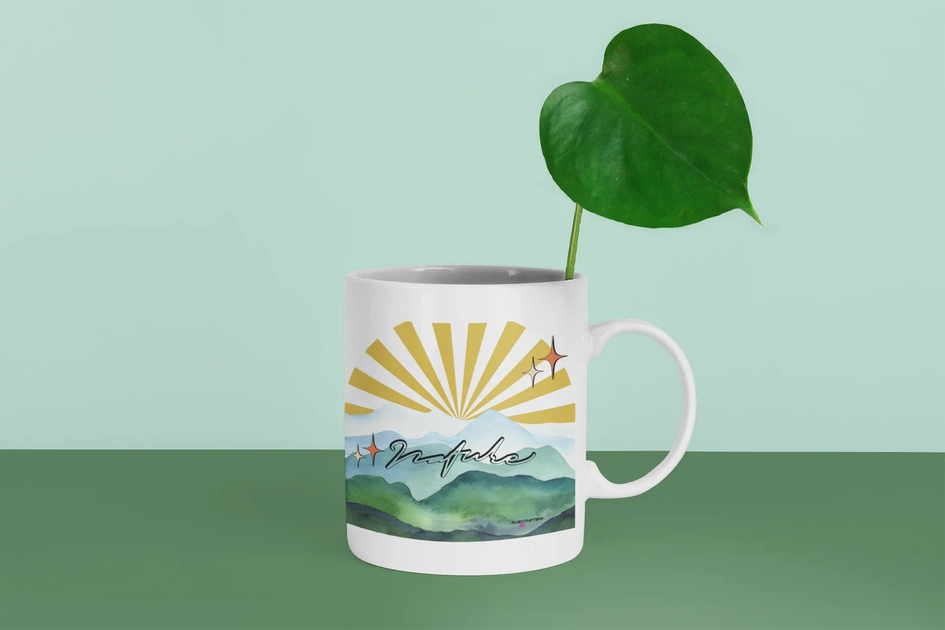 White coffee mug with sunrise landscape print and illustrated starburst on front