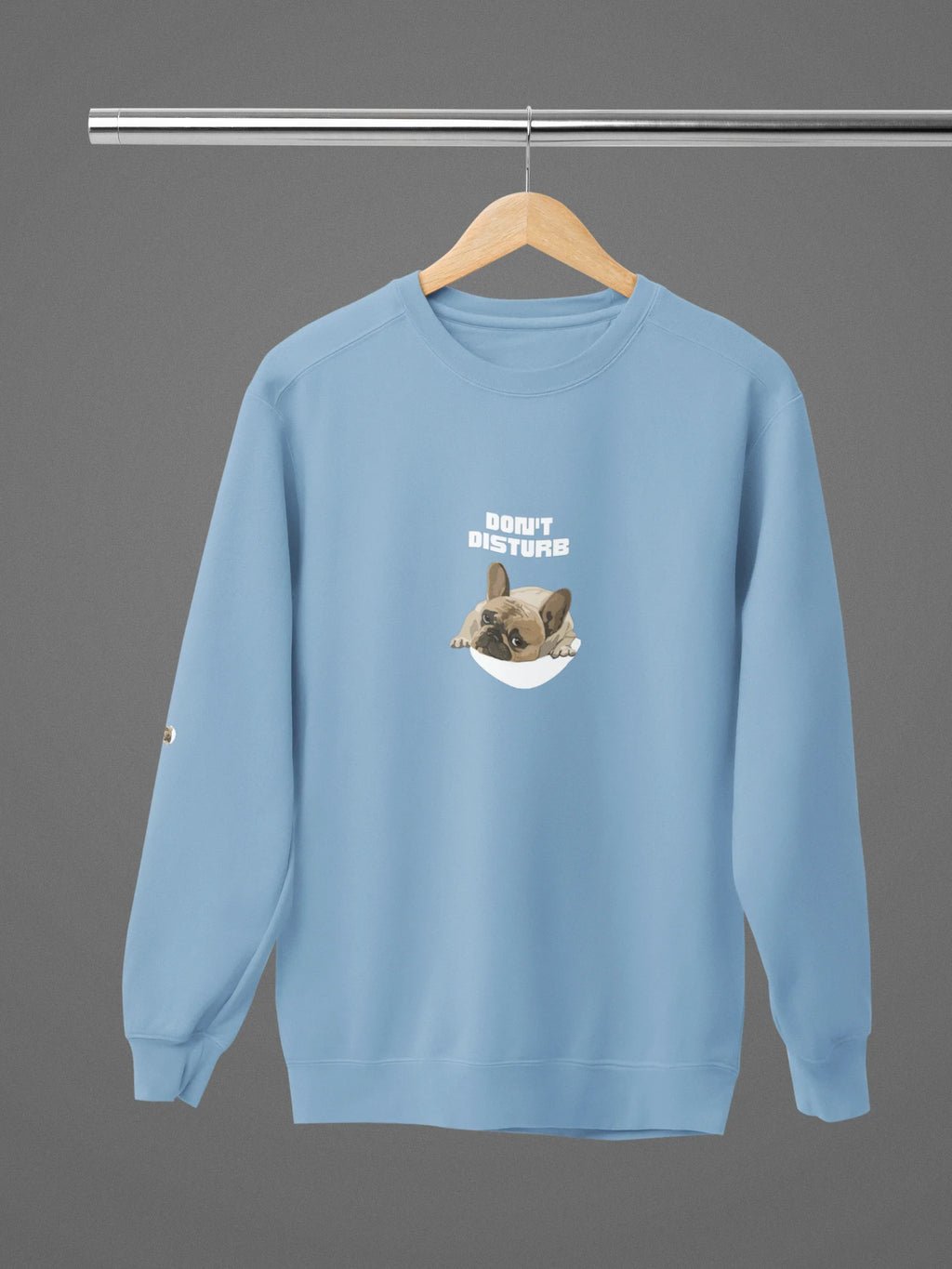 Light blue crewneck sweatshirt with 'DON'T DISTURB' sleeping French bulldog graphic