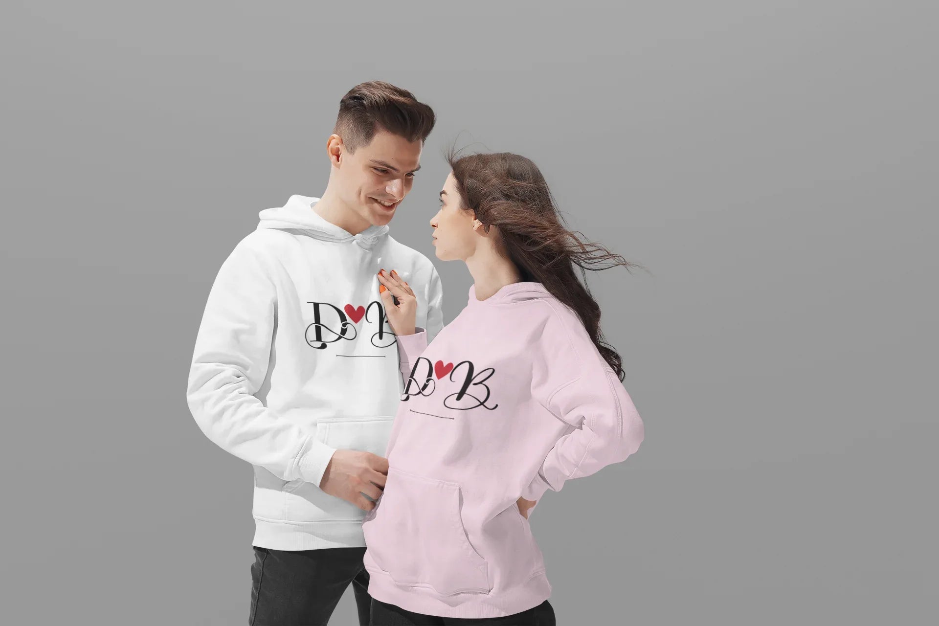 Couples hoodie set, white and light pink, front view with heart monogram design