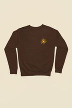 Chocolate sweatshirt with small sun graphic on the front chest.