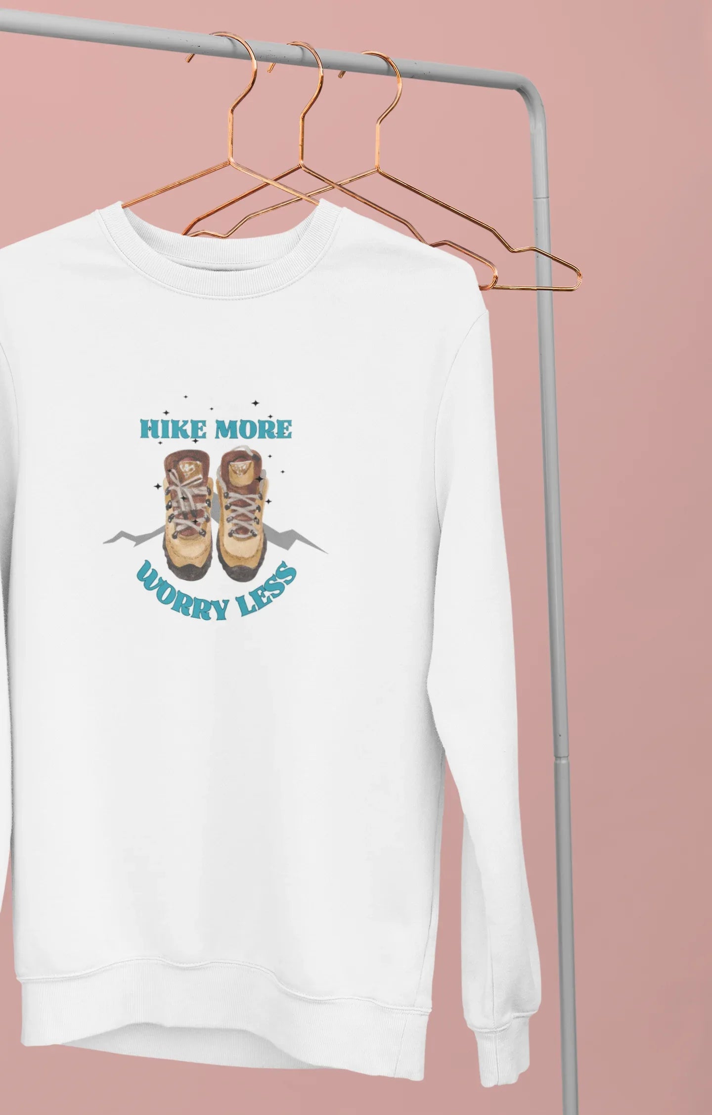 White crewneck sweatshirt on hangers with small 'Hike More, Worry Less' chest graphic