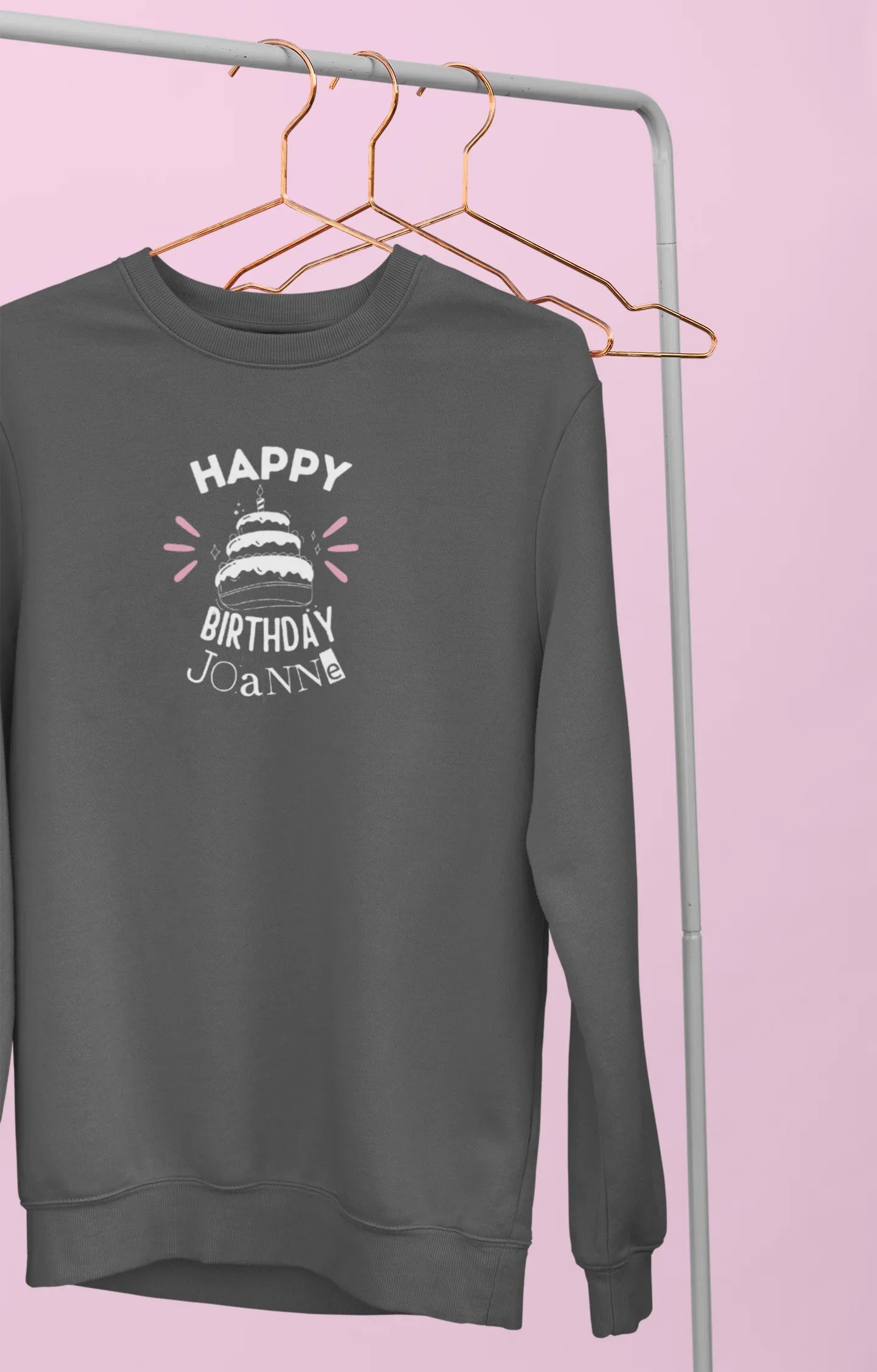 Dark charcoal sweatshirt on hangers with 'Happy Birthday' cake graphic and name text