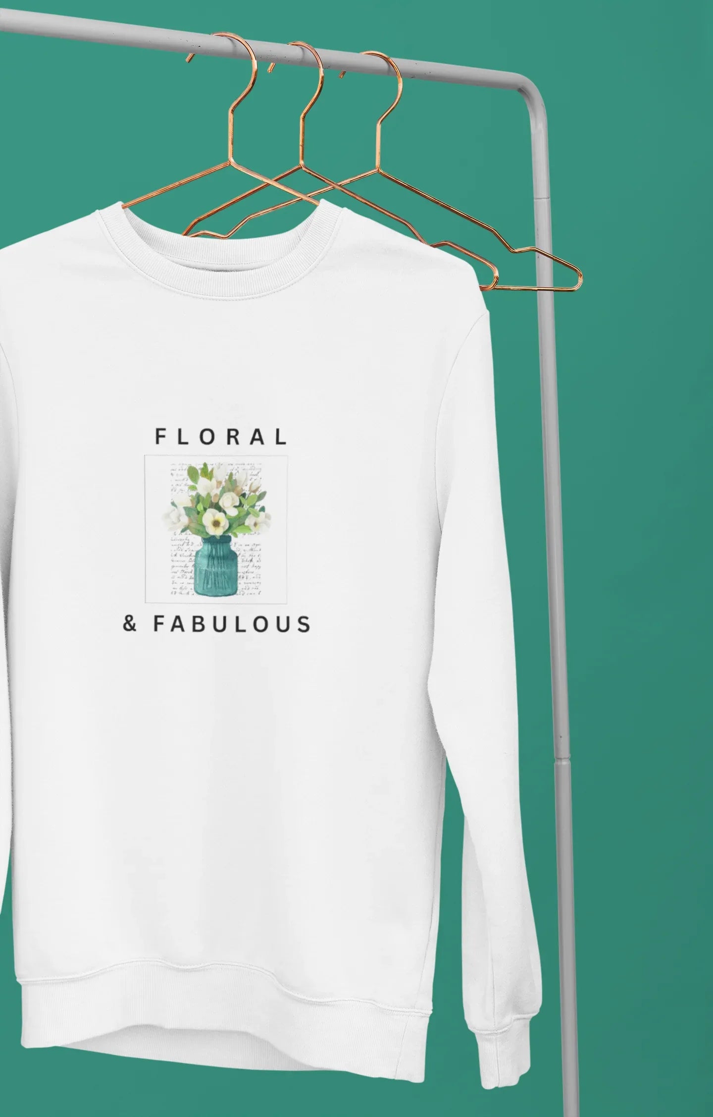 White sweatshirt with small floral vase graphic and 'Floral & Fabulous' lettering