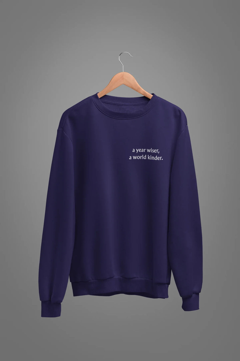 Purple crewneck sweatshirt with 'a year wiser, a world kinder.' print