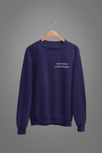 Purple crewneck sweatshirt with 'a year wiser, a world kinder.' print