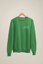 Green crewneck sweatshirt with 'a year wiser, a world kinder.' print