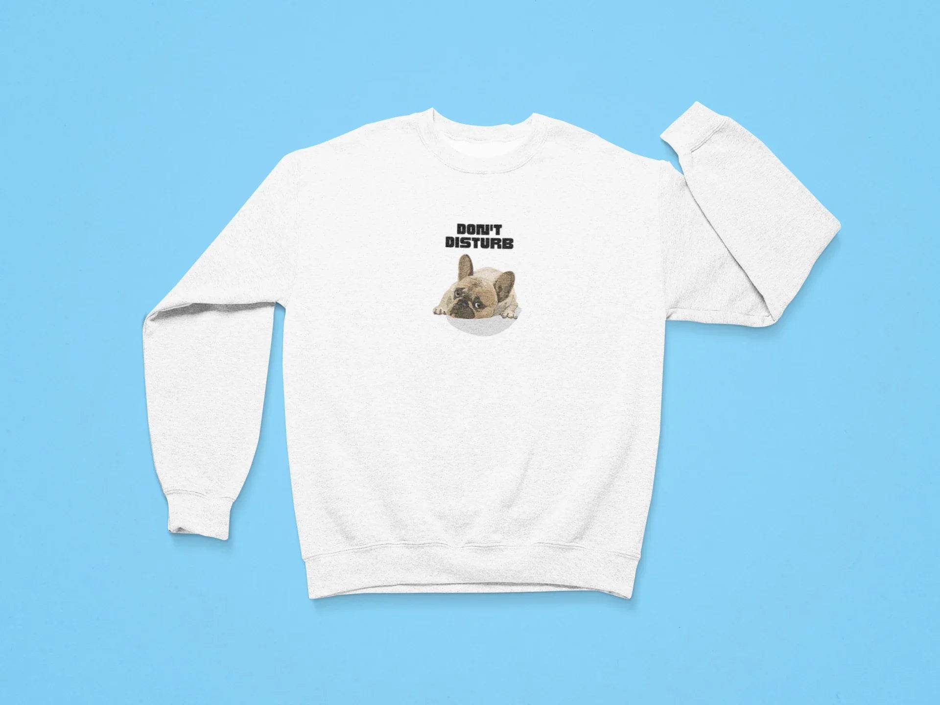 White sweatshirt with “DON’T DISTURB” text and sleeping French Bulldog graphic.