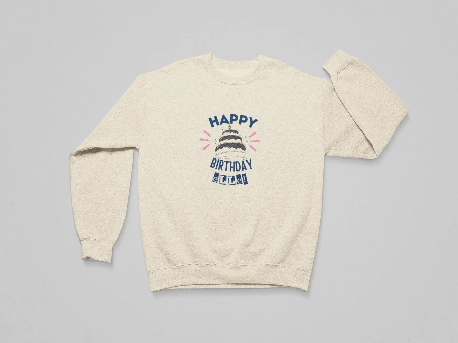 Cream sweatshirt with 'Happy Birthday' cake graphic and custom name text