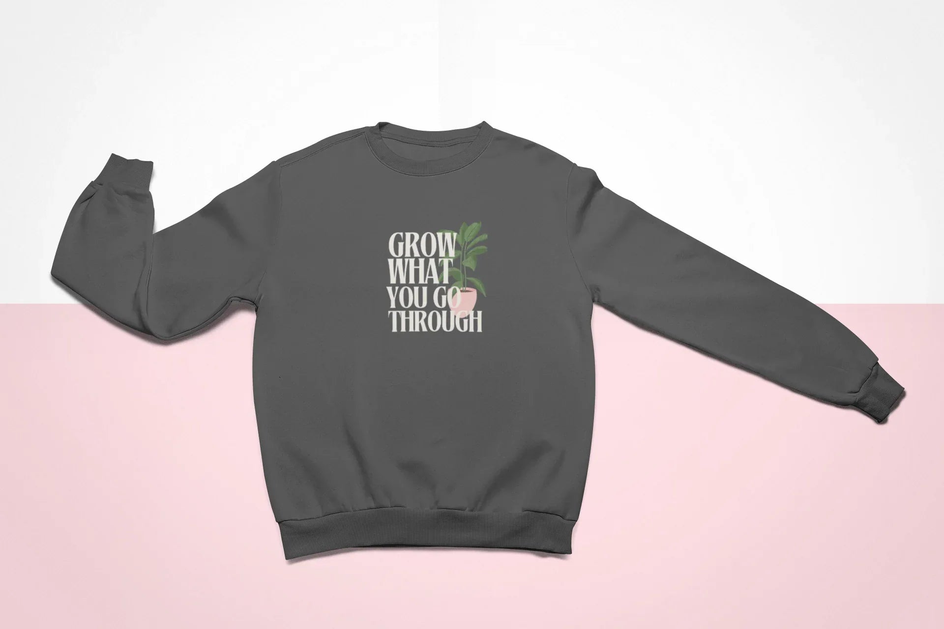 Dark gray sweatshirt flat lay with front “Grow What You Go Through” graphic.
