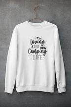 White crewneck sweatshirt hanging with "Loving the Camping Life" graphic on front