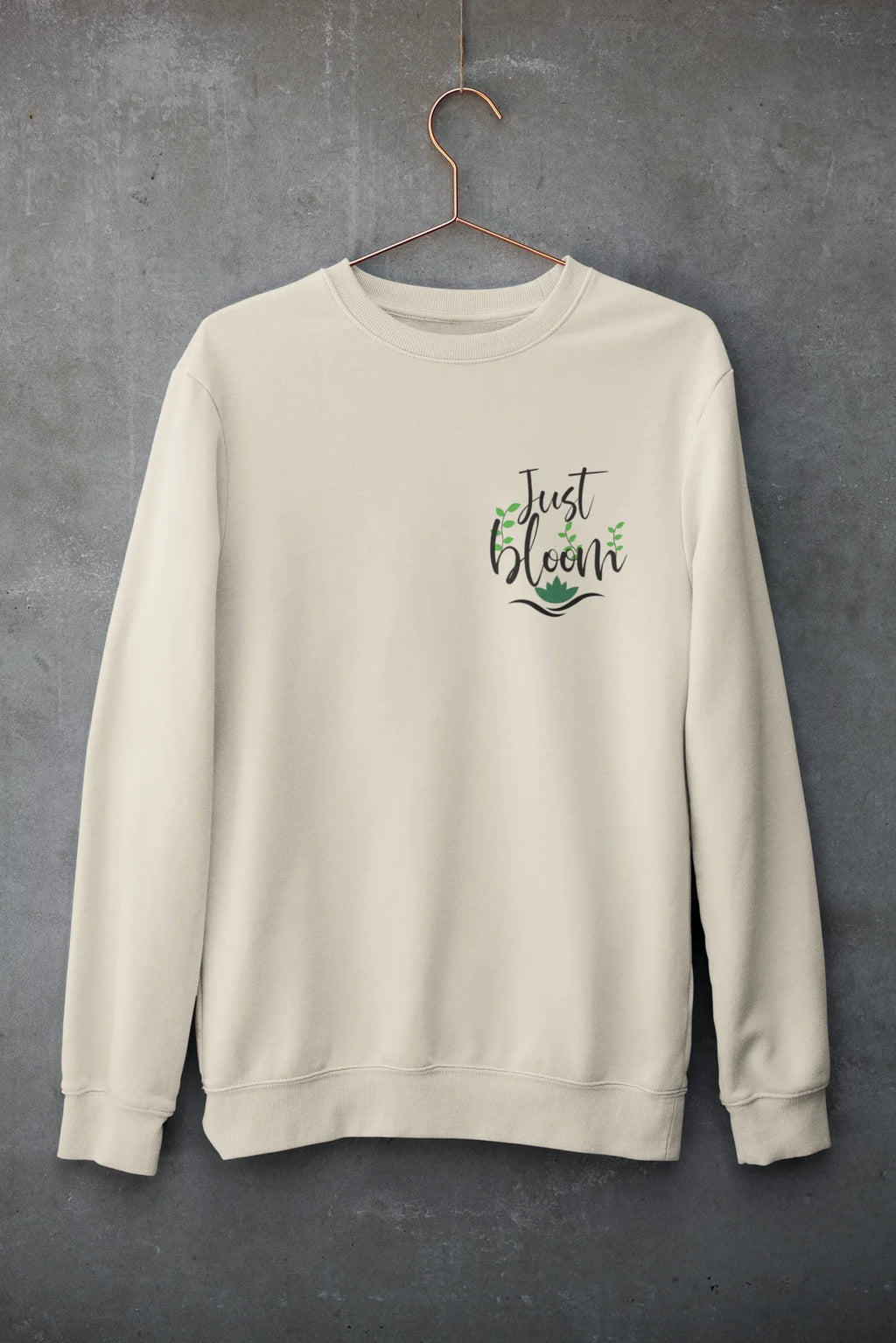 Cream crewneck sweatshirt with floral “Just Bloom” graphic