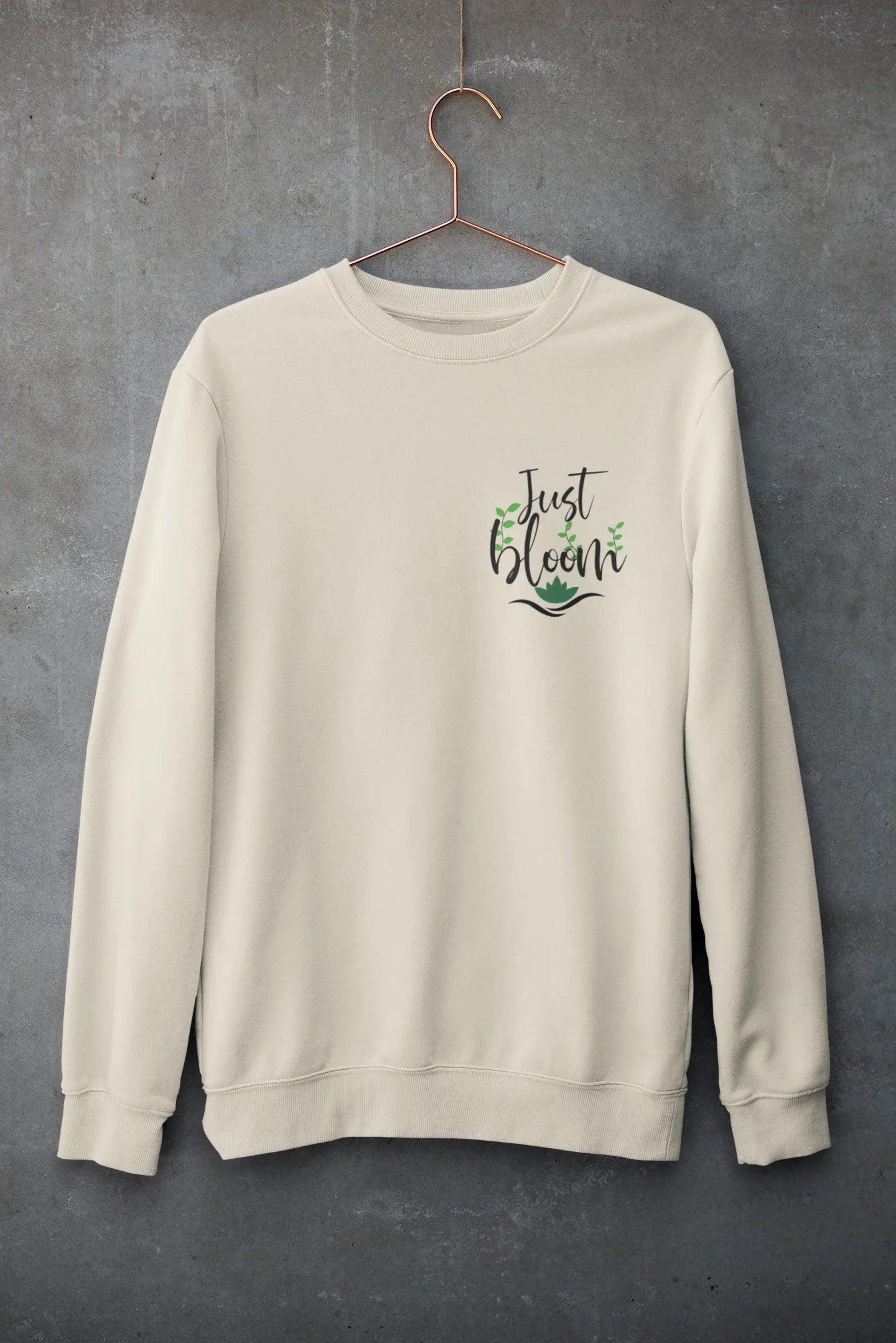 Cream crewneck sweatshirt with floral “Just Bloom” graphic
