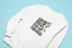 White sweatshirt with front “Grow What You Go Through” graphic.