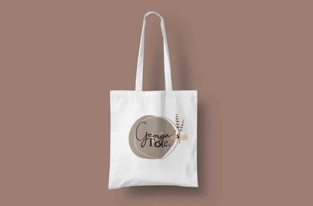 White canvas tote bag with short handles and Lena's Tote round logo