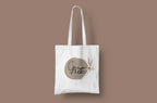 White canvas tote bag with short handles and Lena's Tote round logo