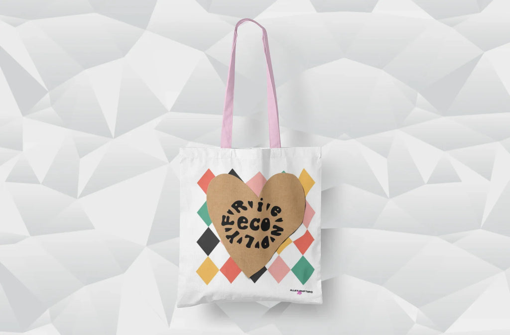 White heart-print tote bag with tan heart graphic and multicolor diamonds, pink handles