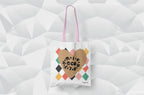 White heart-print tote bag with tan heart graphic and multicolor diamonds, pink handles