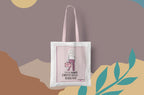 White canvas tote bag with pink graphic panel, shown centered against artwork.