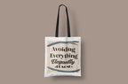 White canvas tote bag with short handles, "Avoiding Everything Elegantly" print