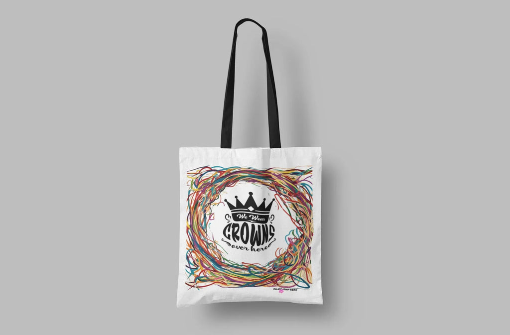 White tote bag with black crown logo and colorful scribble wreath