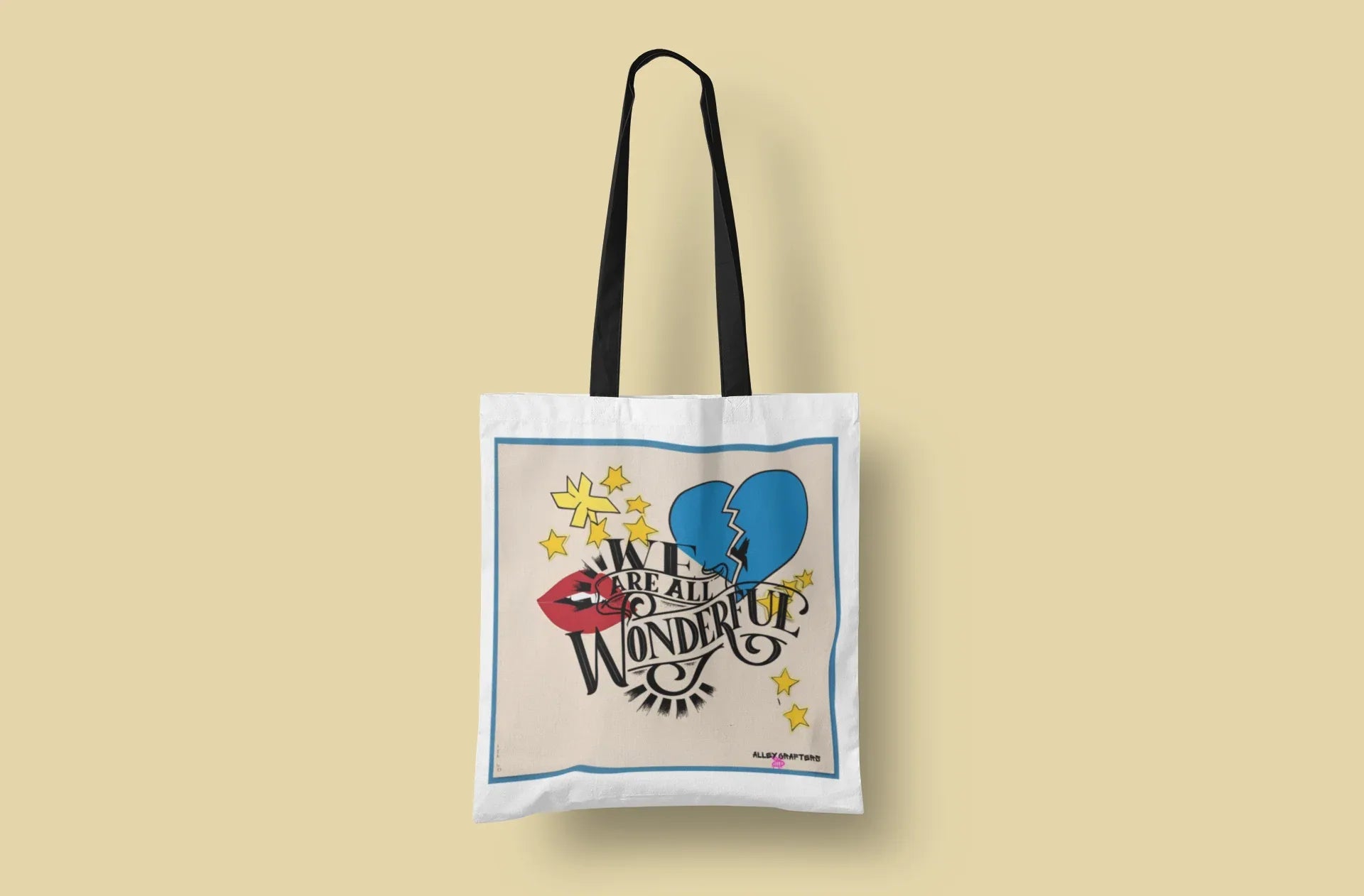 White tote bag with black handles and blue border heart and stars graphic