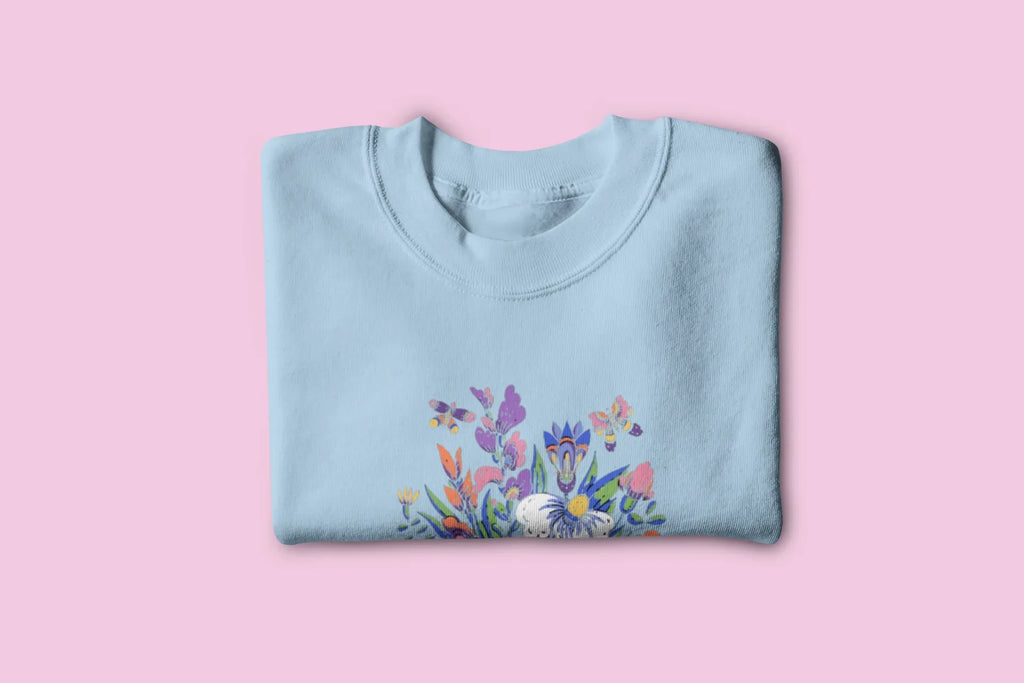 Light blue floral crewneck sweatshirt with colorful garden graphic on front