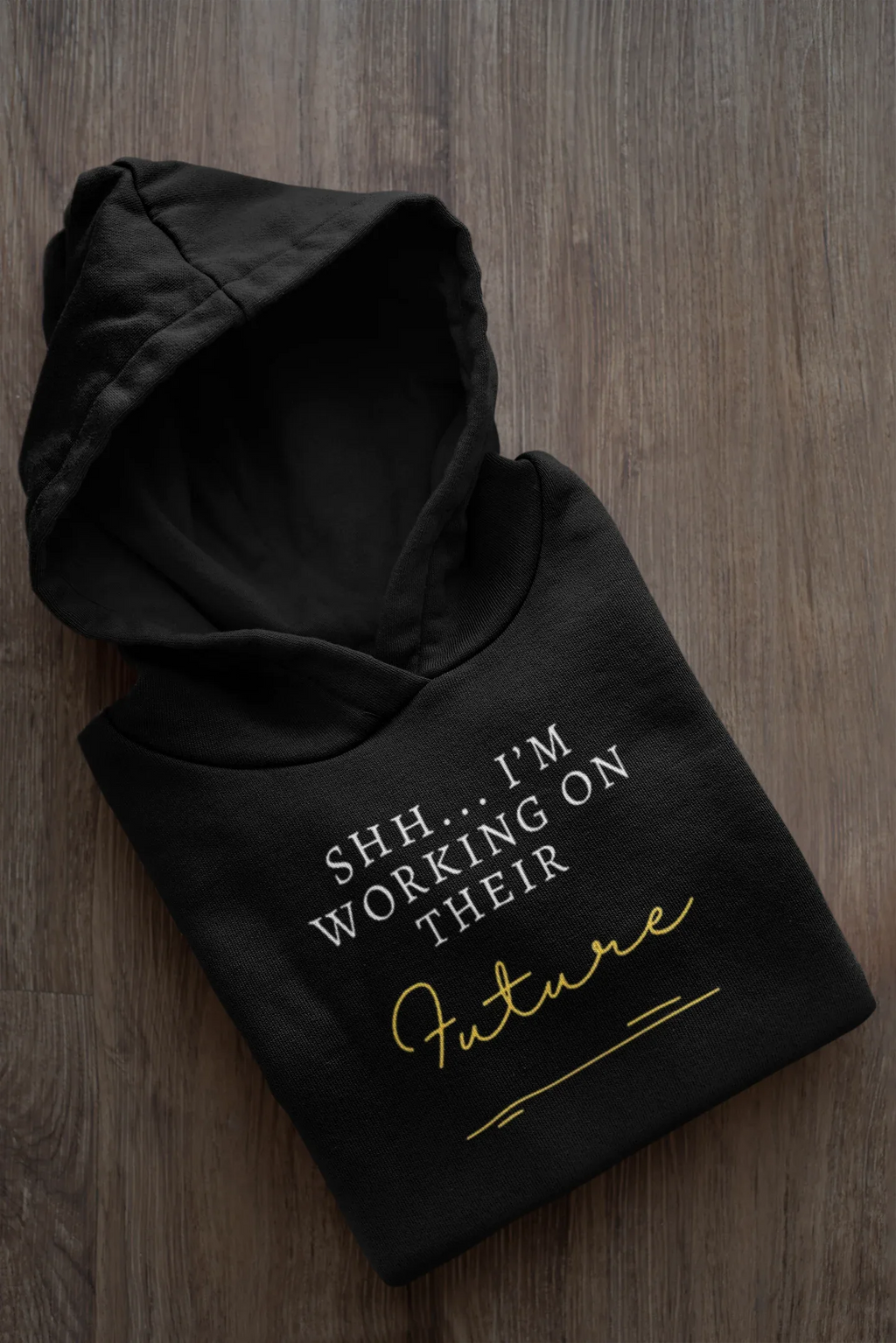 Black hooded sweatshirt, folded, with 'Future' script and 'I'm Working on Their' text