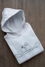 Light blue unisex hoodie folded flat; line-art wedding rings graphic with text on front.