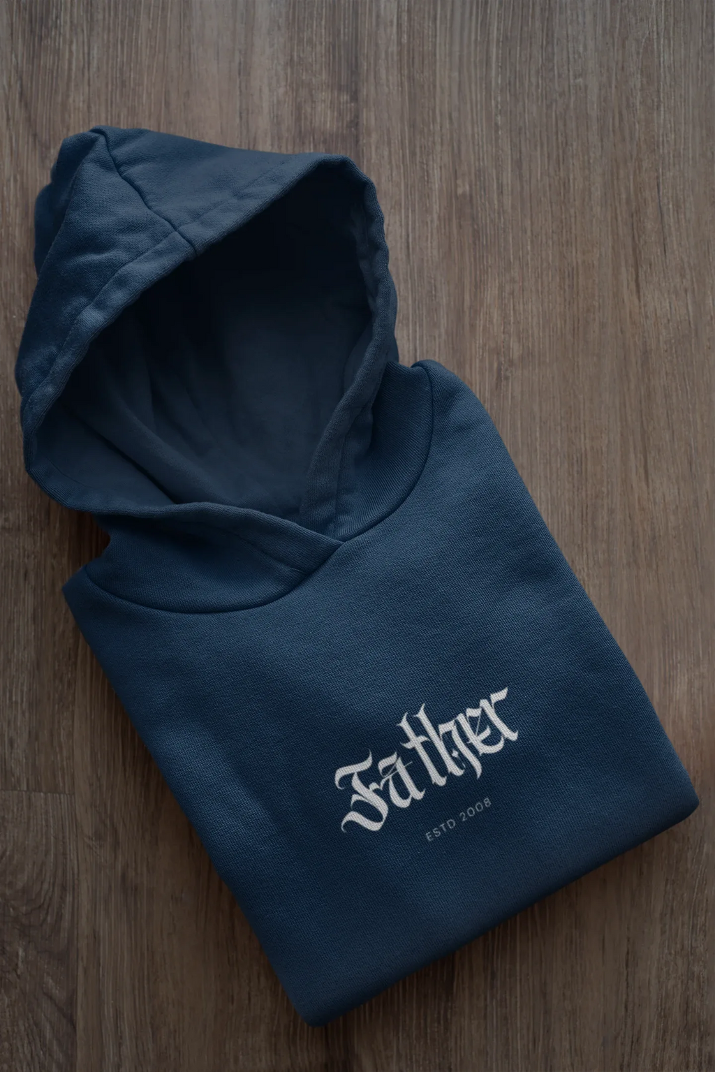 Navy hoodie folded flat, hood and front pouch pocket, “Father” logo on chest