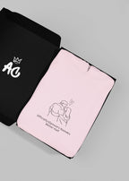 Light pink hooded sweatshirt folded flat with couple graphic on center