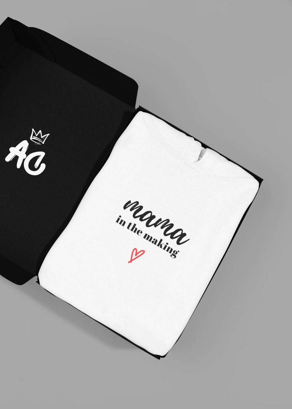 Black and white hooded sweatshirts showing 'mama in the making' print with red heart