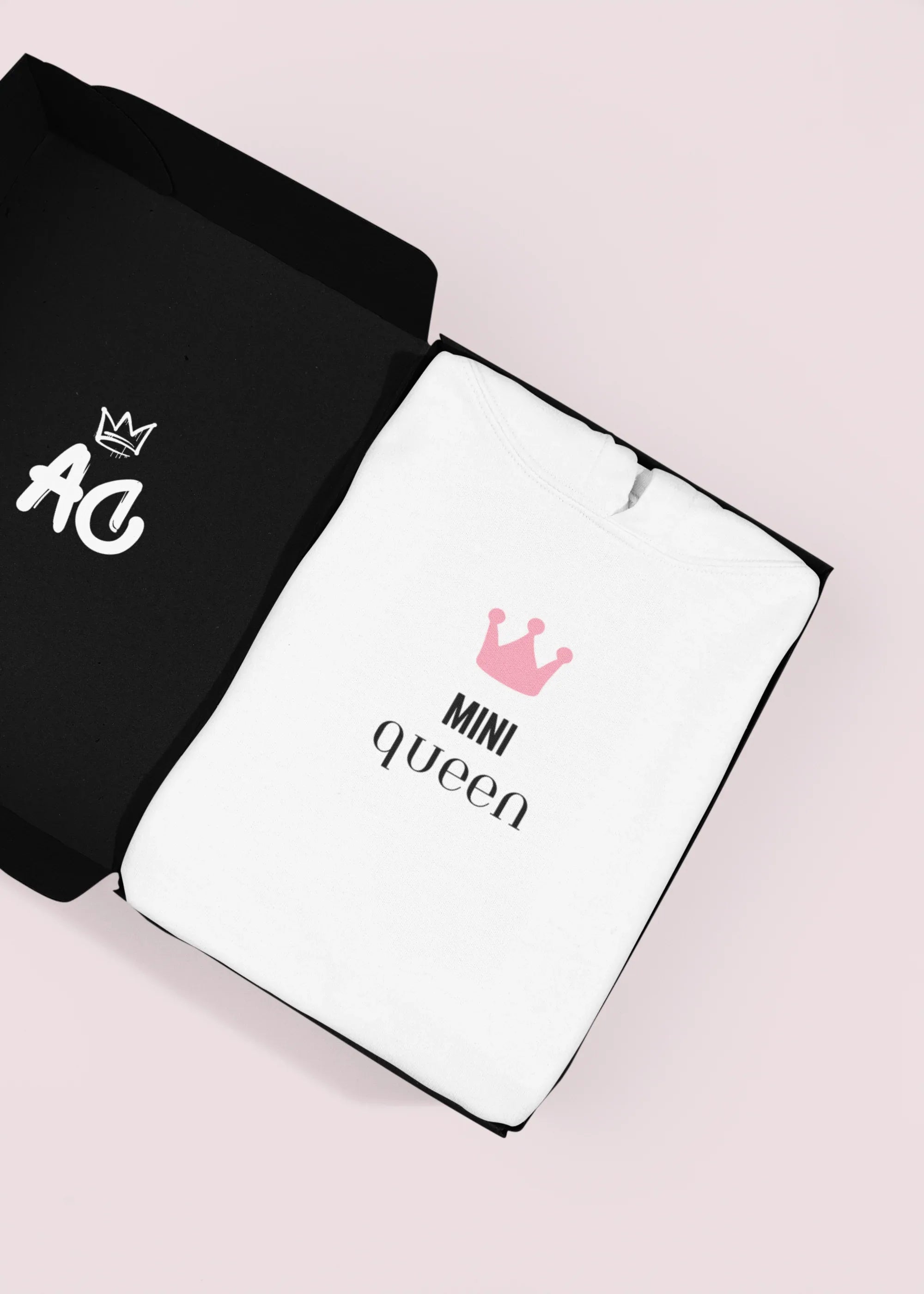 White hooded sweatshirt with 'Mini Queen' crown graphic on the front