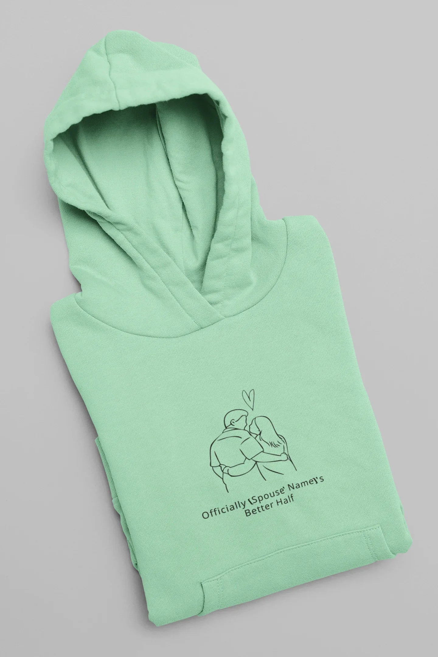 Mint green hooded sweatshirt folded with front couple graphic and hood
