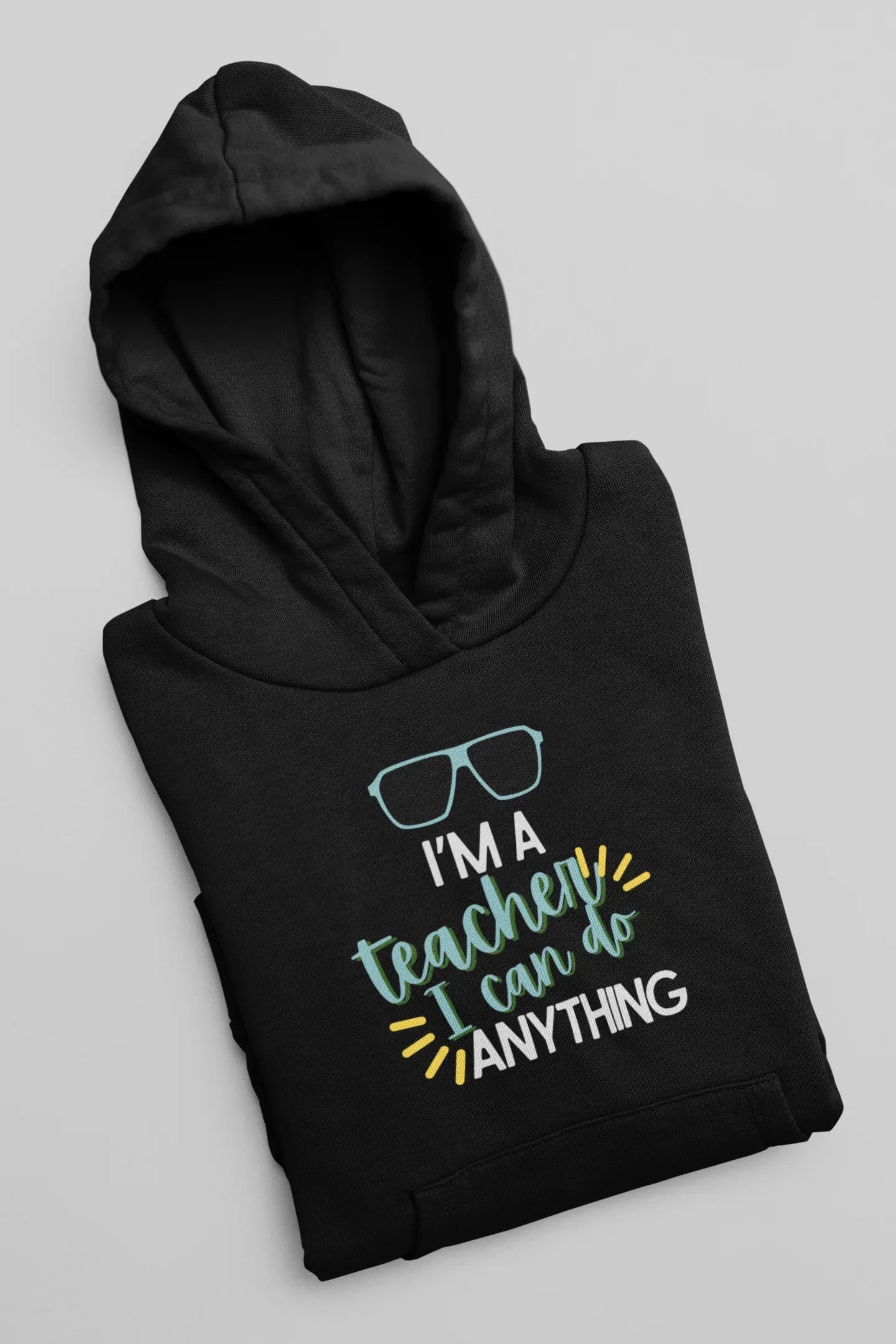 Black unisex hoodie laid flat with hood and front teacher slogan graphic