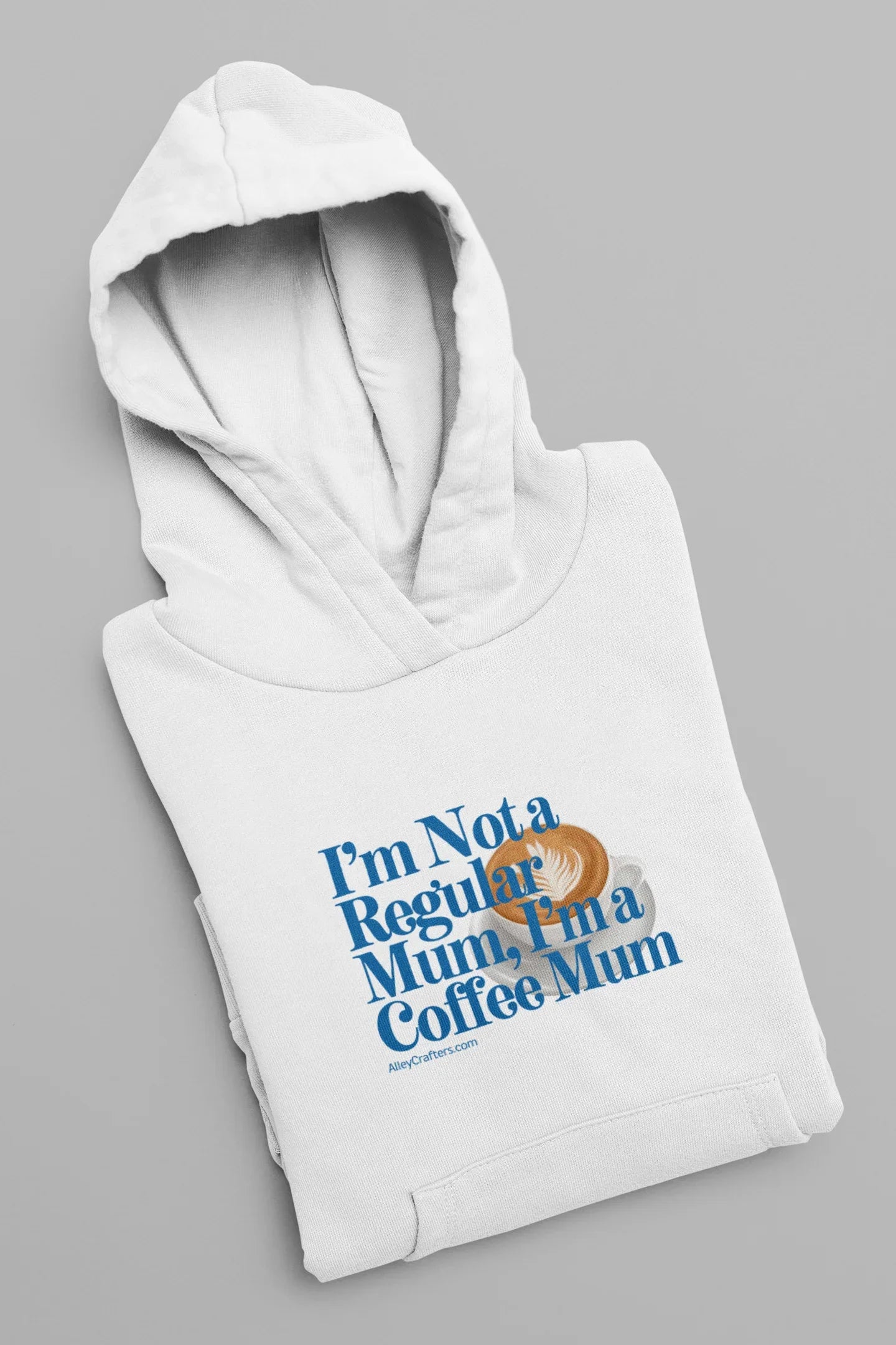 White hoodie sweatshirt folded with hood and blue “Not a Regular Mum, Coffee Mum” print