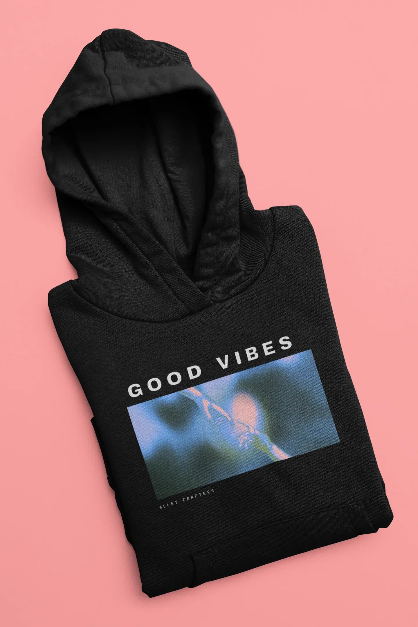 Black unisex hoodie lying flat, 'GOOD VIBES' graphic across chest