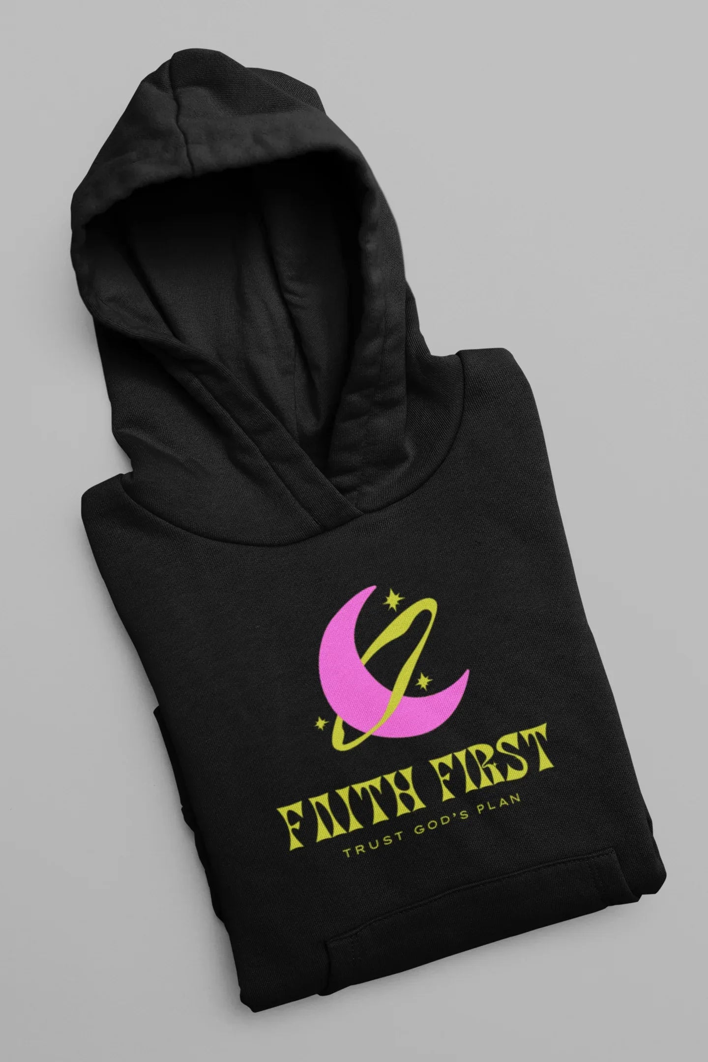 Folded black unisex hoodie with Faith First crescent logo on chest