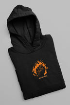 Black hooded sweatshirt with orange flame face logo on chest, folded flat