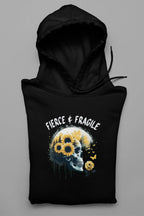 Black hooded sweatshirt laid flat with front graphic skull and flower design, drawstring hood and pocket.