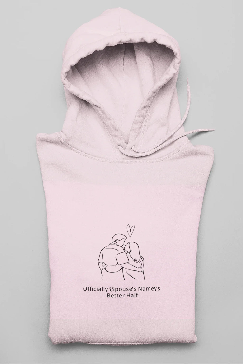 Light pink hooded sweatshirt folded with front couple graphic and drawstring hood