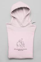 Light pink hooded sweatshirt folded with front couple graphic and drawstring hood